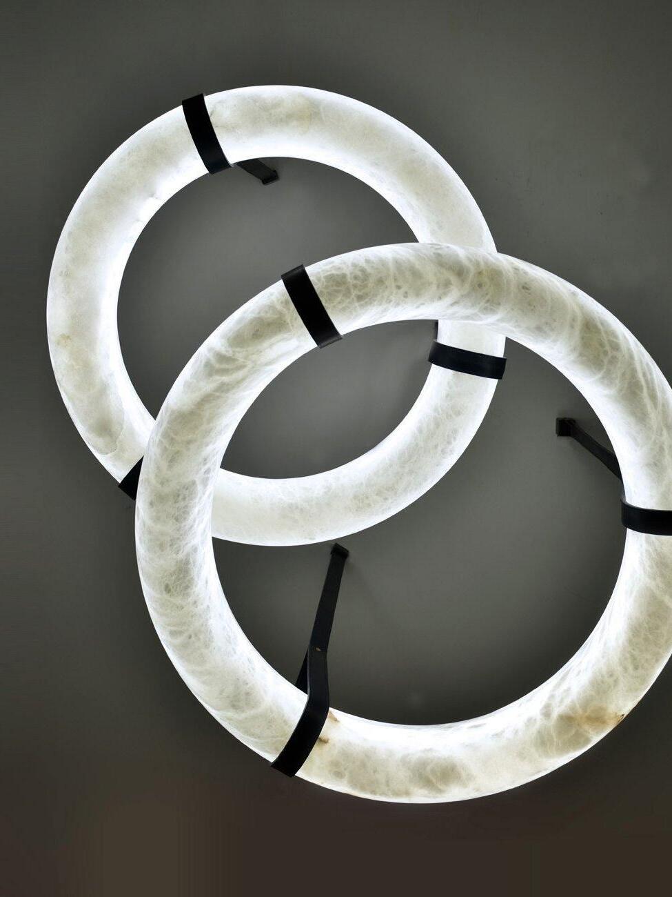 Two overlapping upright ring forms
