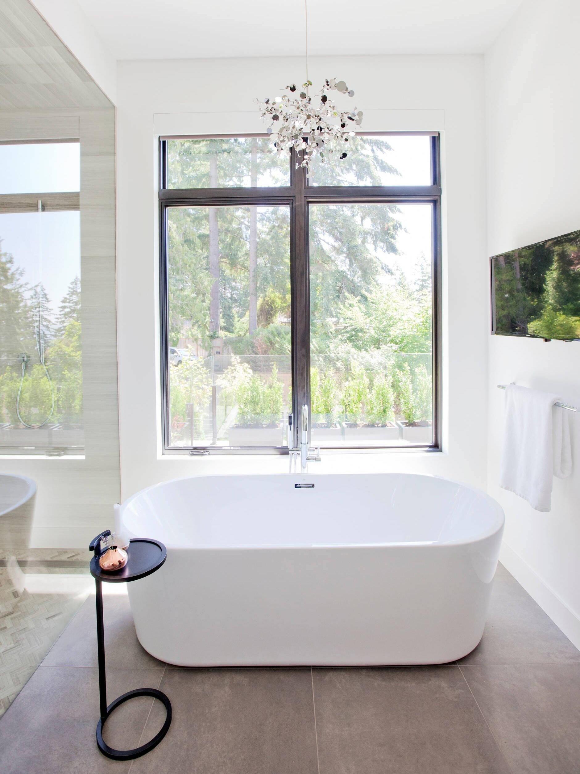 Silver disc cluster above a white freestanding bath