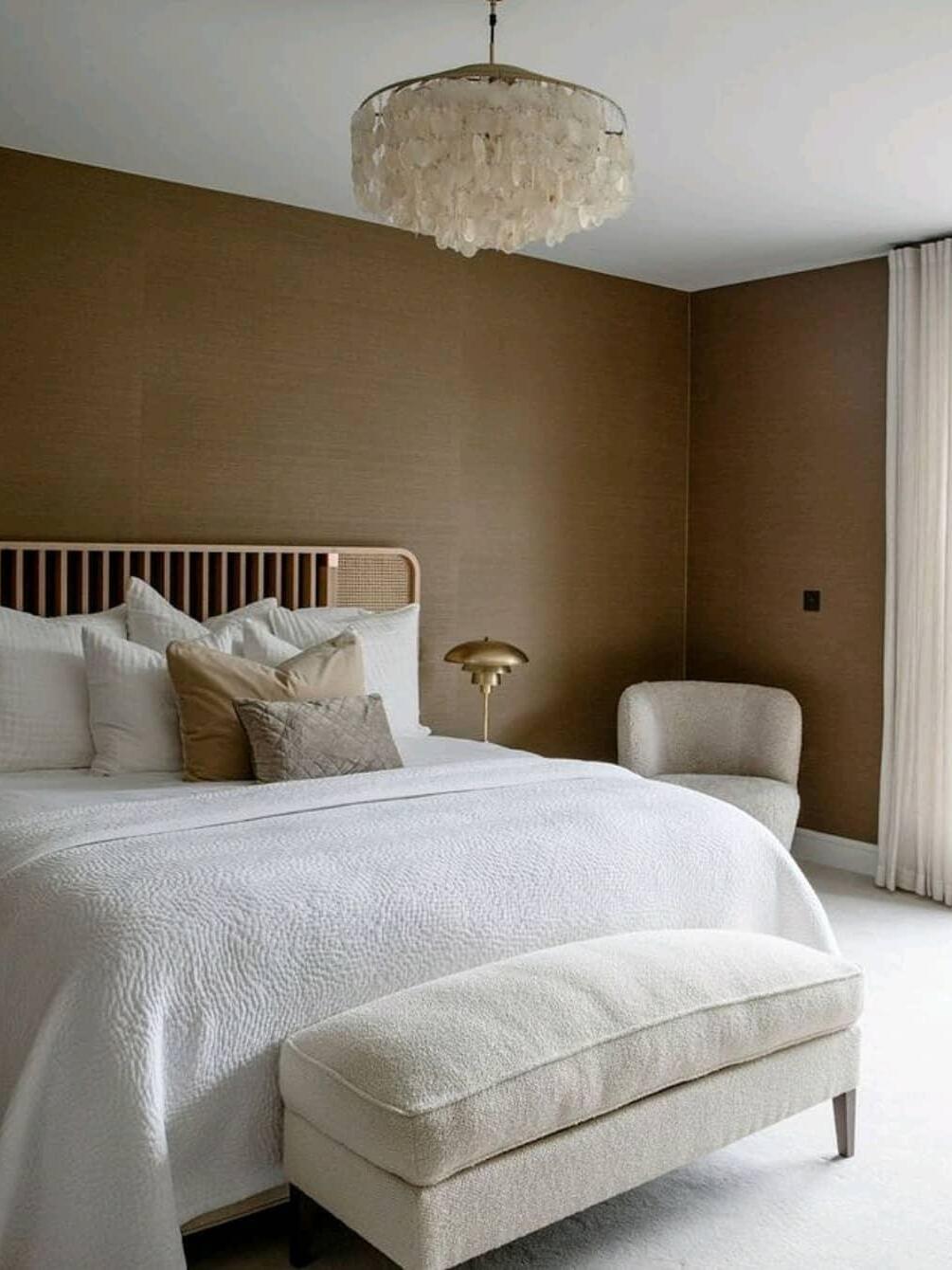Round shell chandelier above a bed