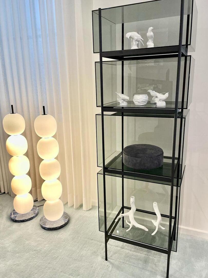 Two globe floor lamps near shelving