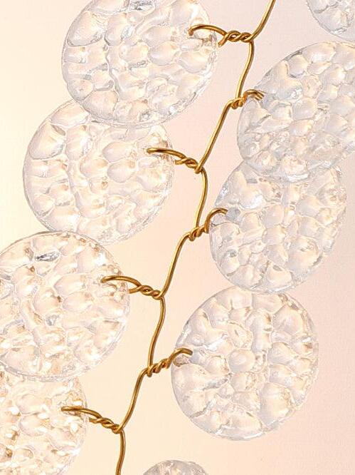 Textured coin-like discs attached to small links