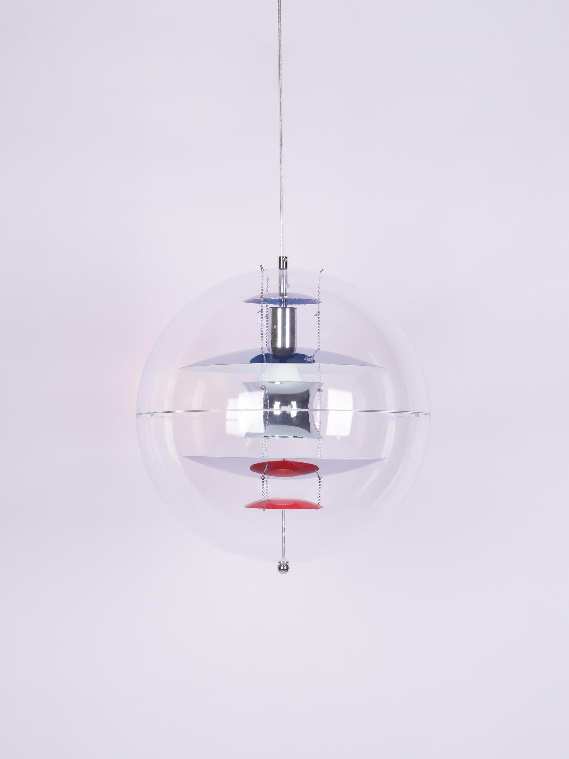 Isolated chrome-tone reflector globe with a light-coloured cable, equatorial seam and blue and red internal discs