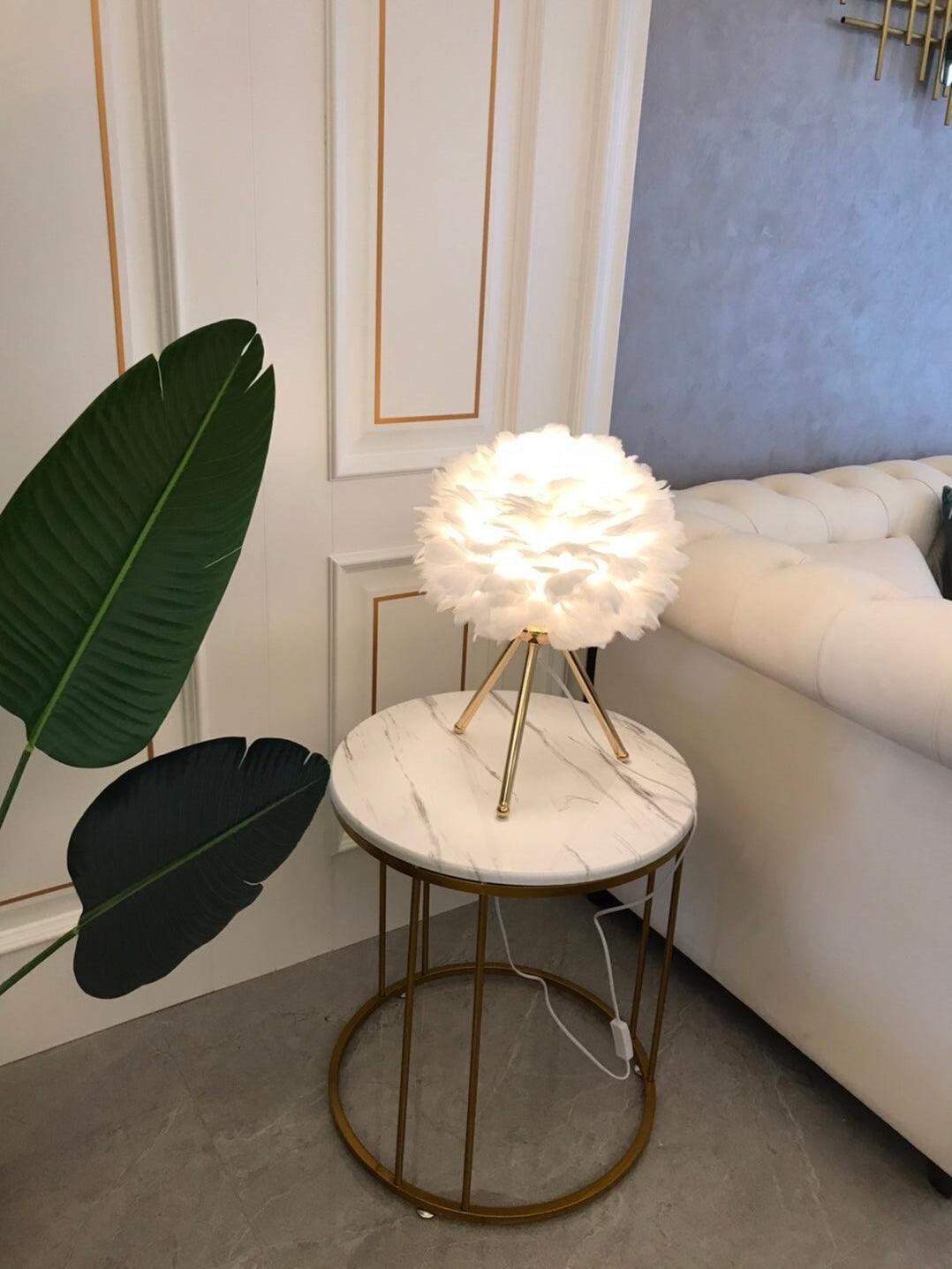 White feather lamp on round side table