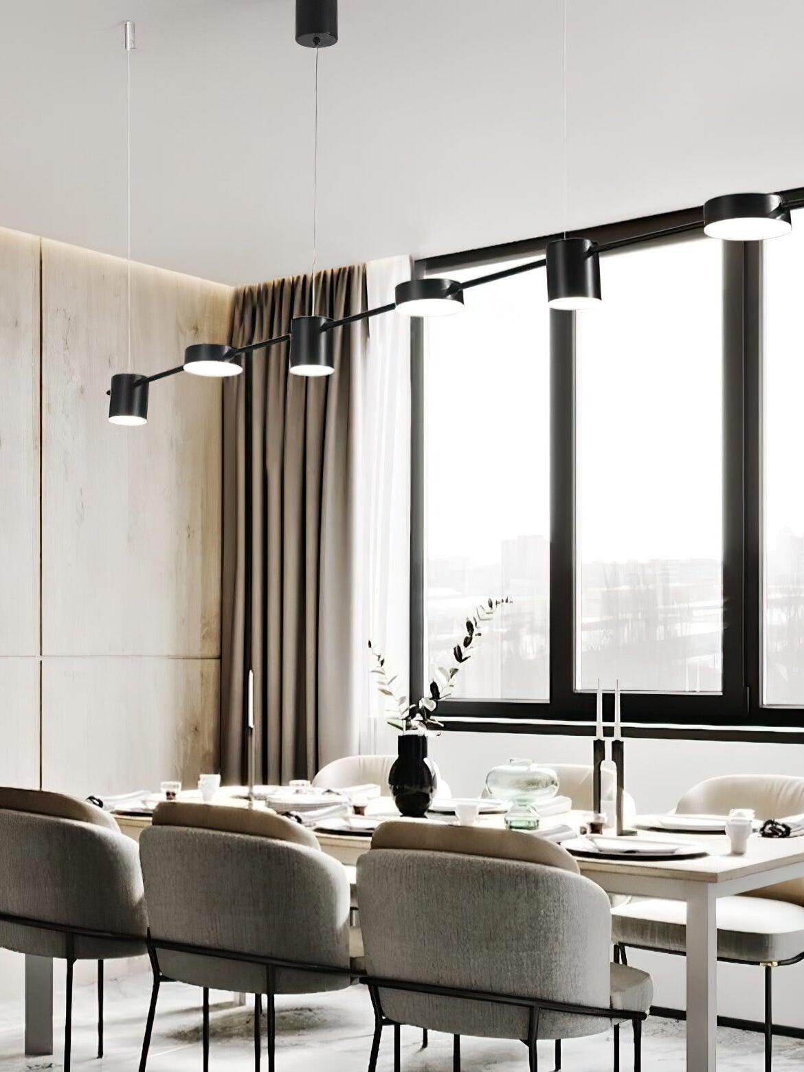 Linear pendant above a dining area beside tall windows