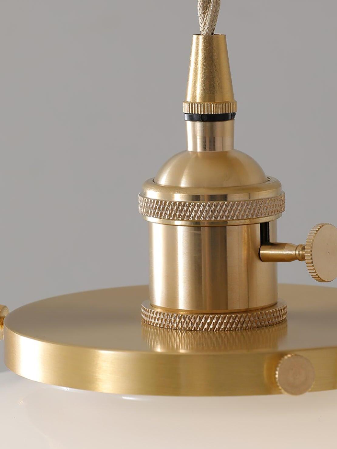 Atlas brass holder close-up showing knurled bands, side knob, shade-retaining rim and twisted-looking suspension cord