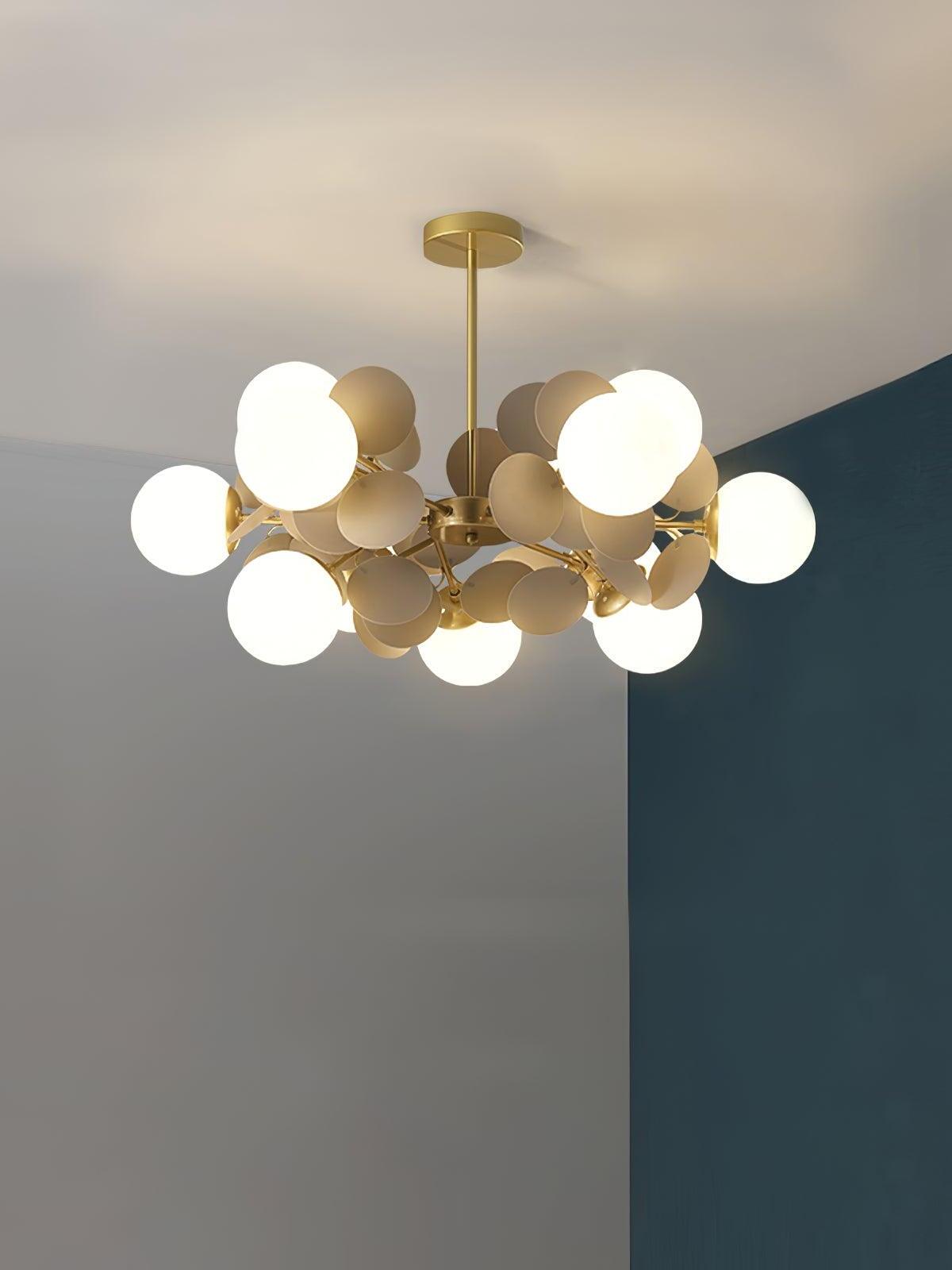 Gold chandelier with twelve white globes among grey rounded discs