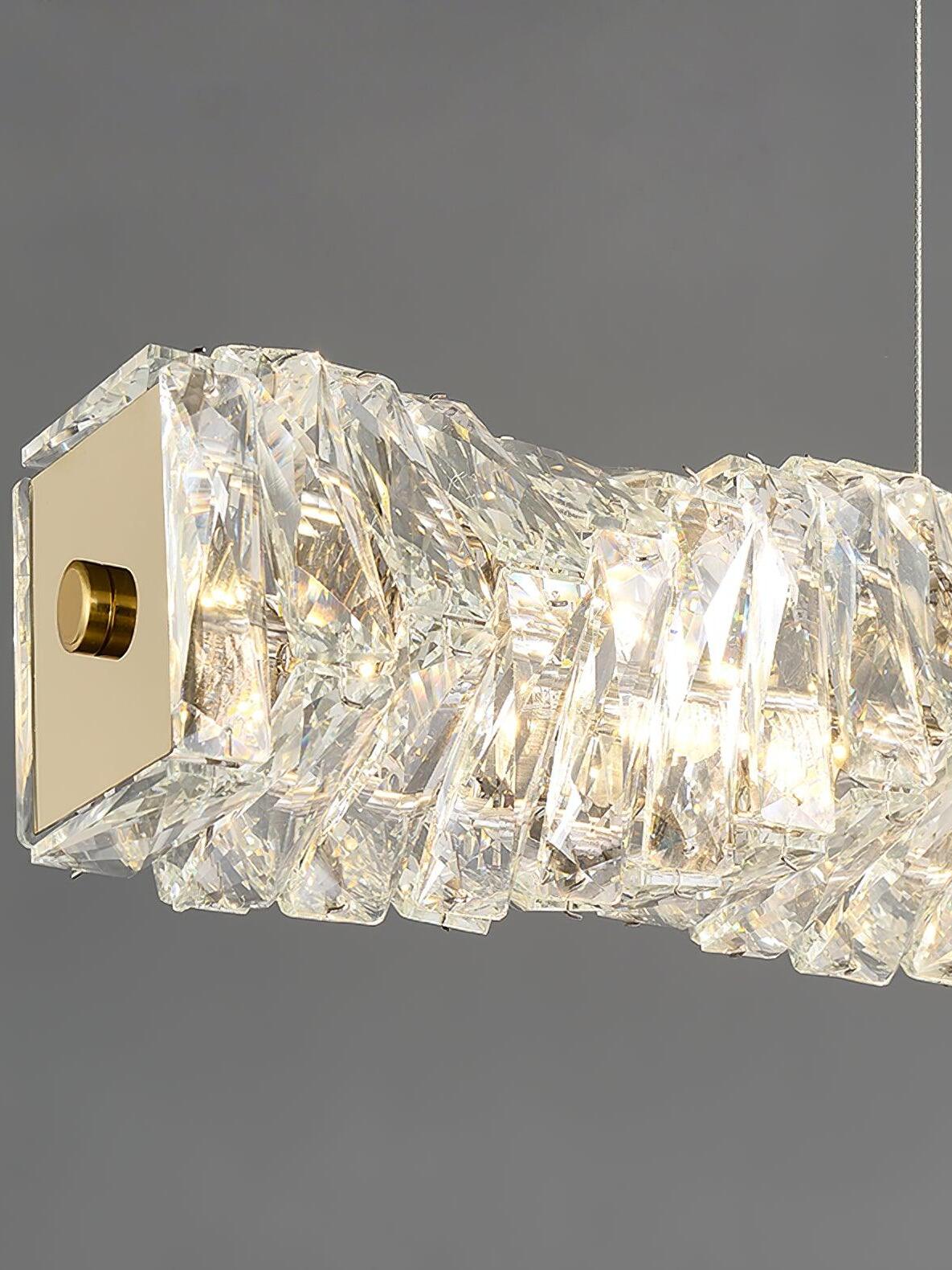 Close view of the gold square end plate, central round fitting and illuminated clear crystal pieces