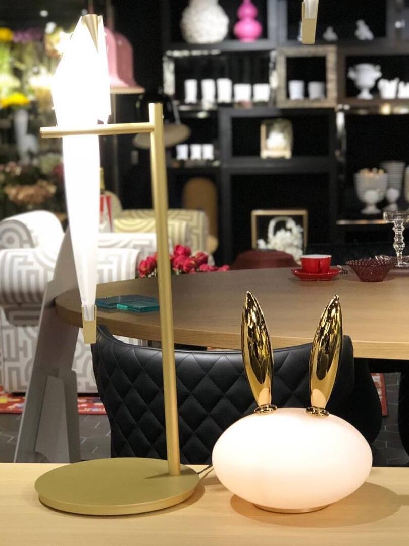 Glowing rabbit with gold-tone long ears beside separate slender table light