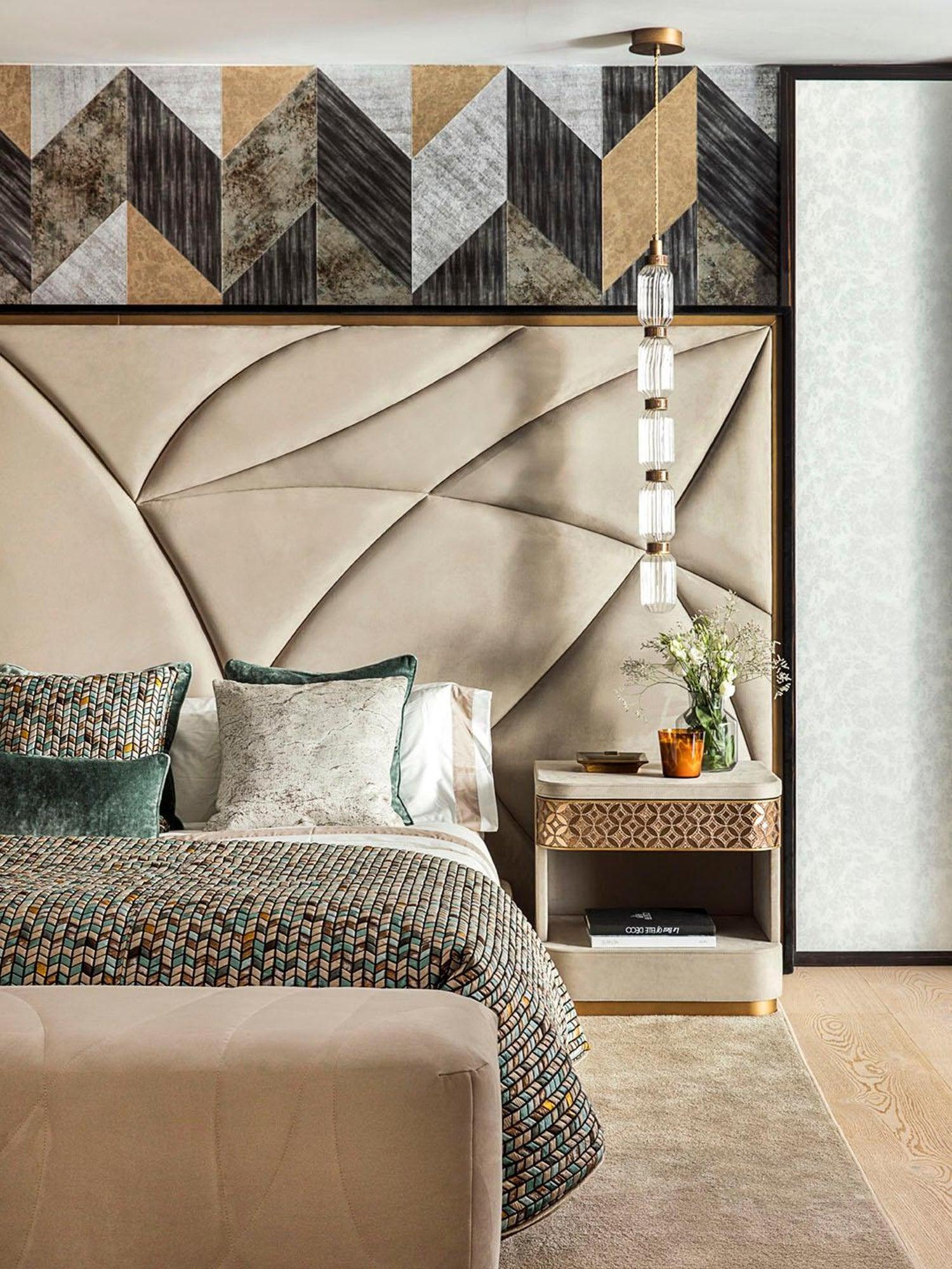 Slim pendant hanging beside a bed and bedside table
