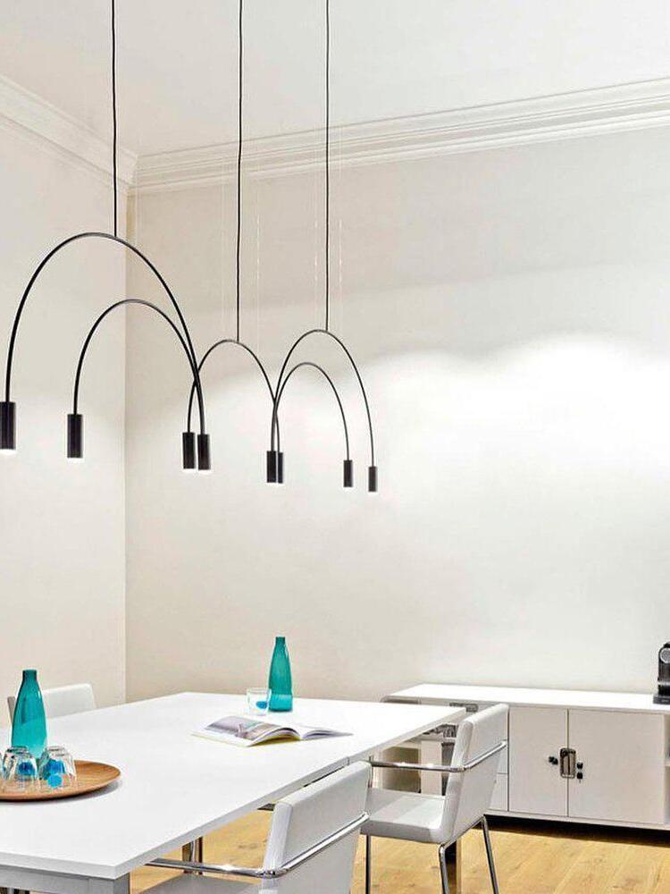 Black arched pendant above a kitchen island