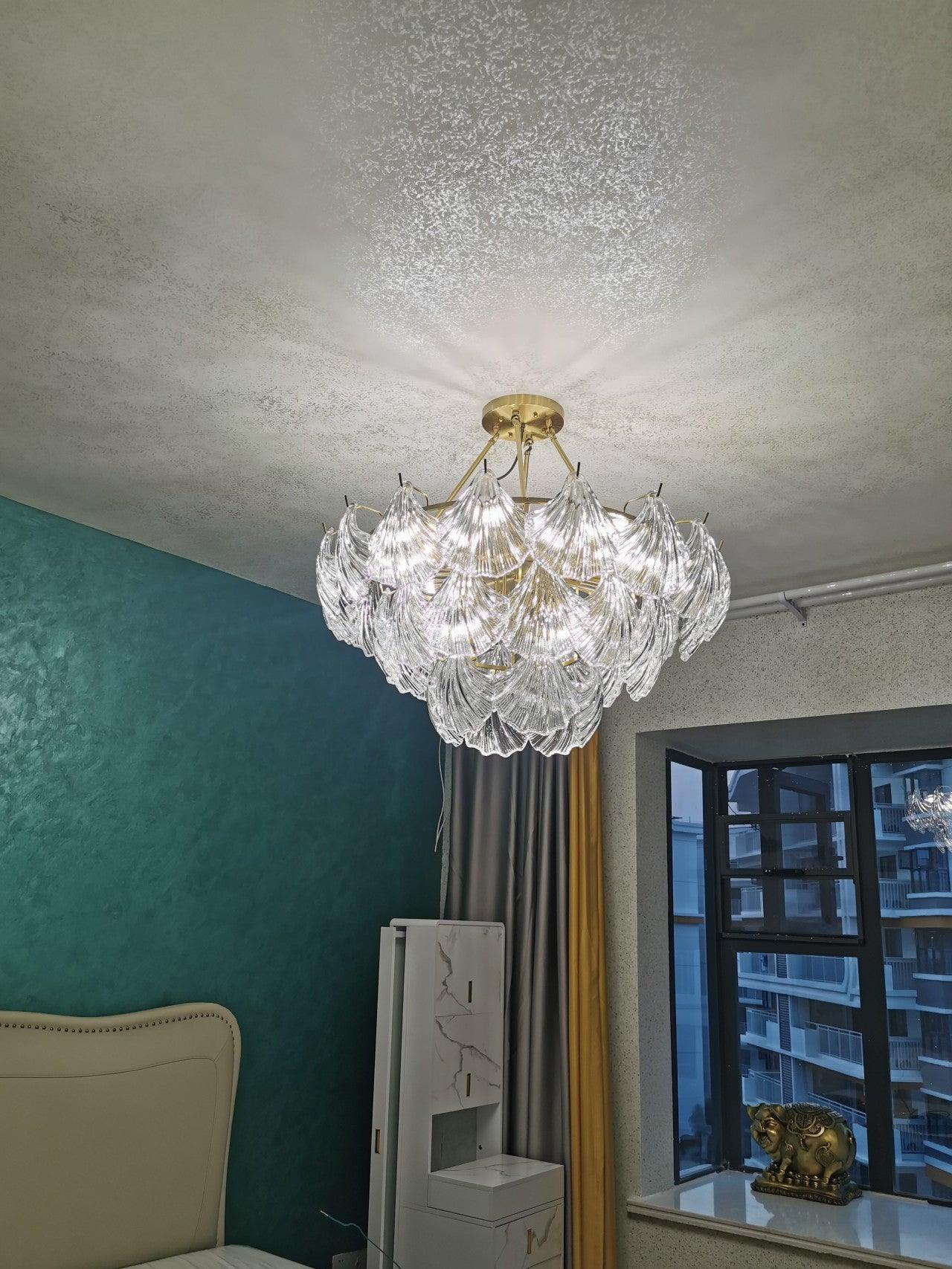 Glass ceiling light in a green bedroom beside a window and white cabinet