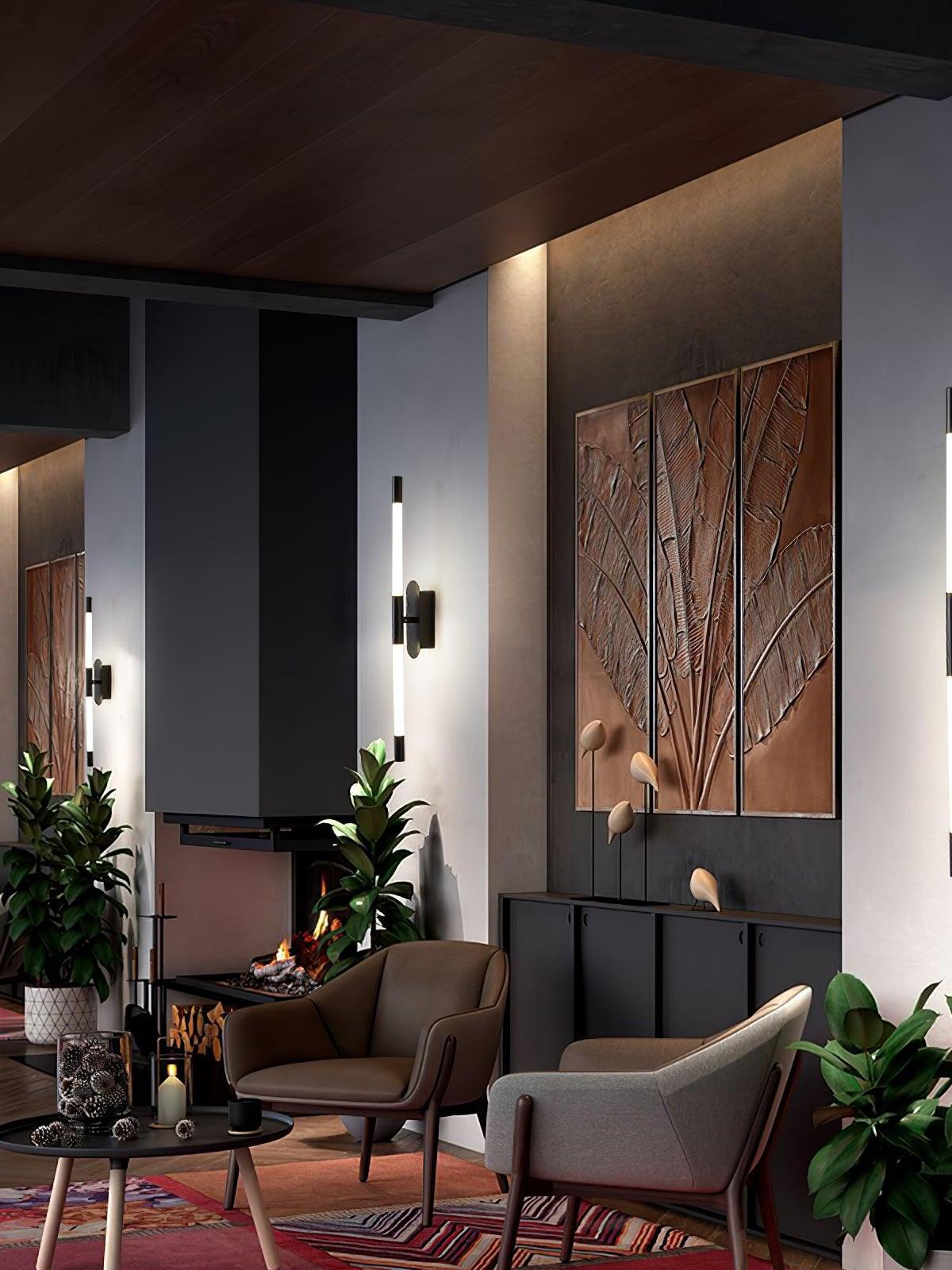 Black Agnes wall lights in a lounge with chairs, plants and framed wall art