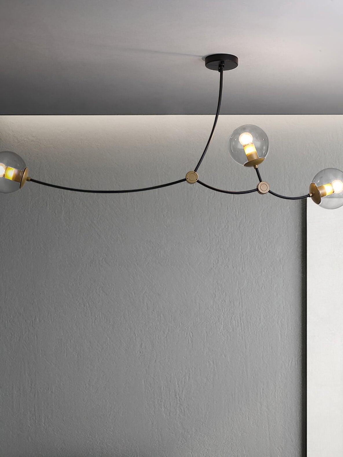 Curved black branches carrying clear glass globes