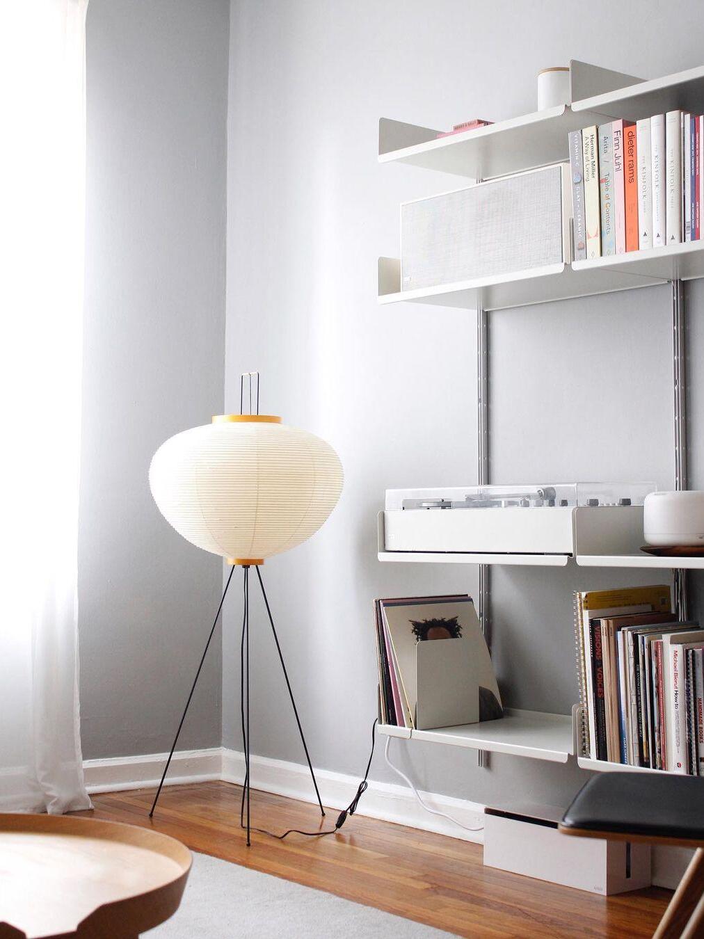 Round paper lamp near white bookcase