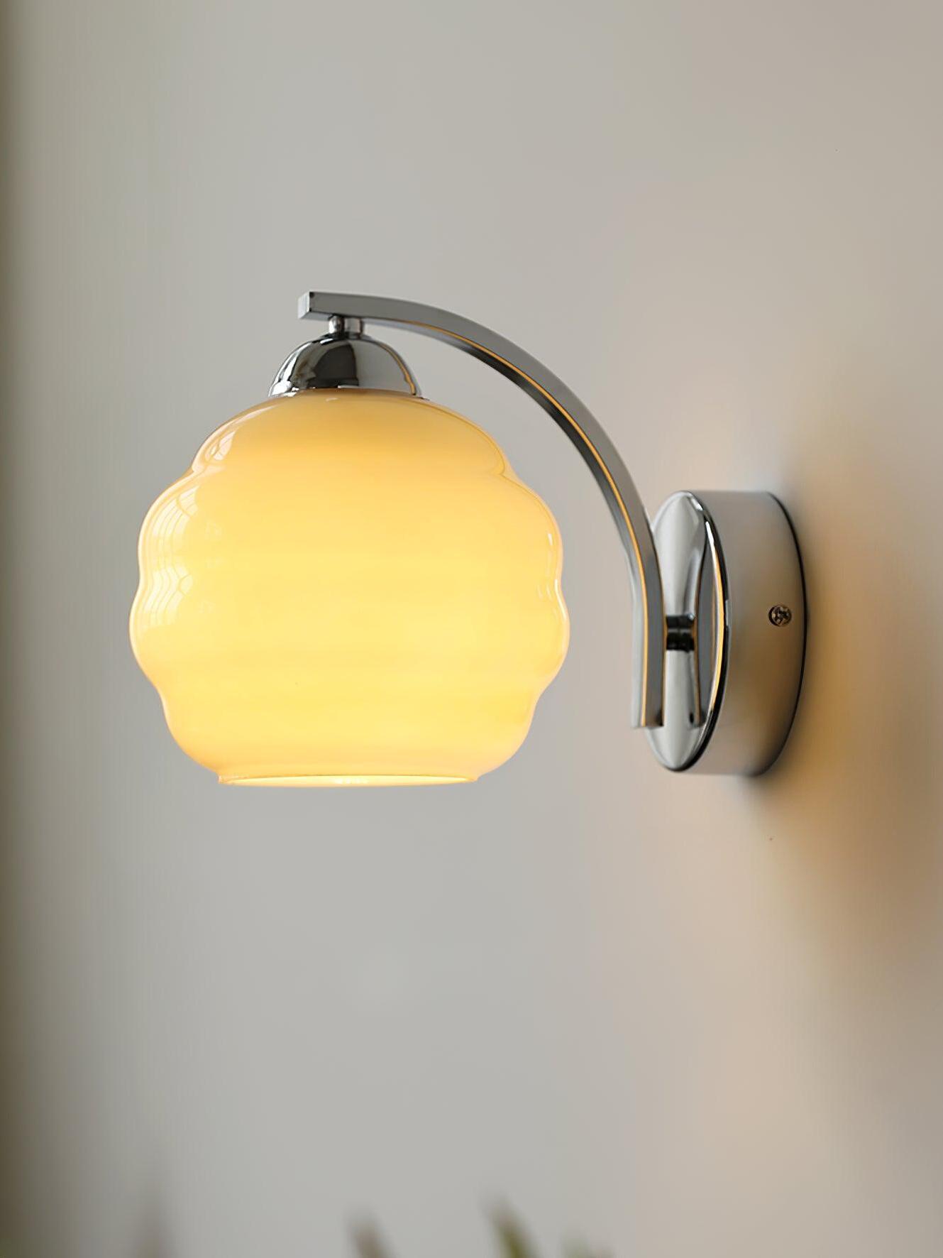 Chrome curved arm and right-hand backplate with a yellow-lit contoured shade and visible lower opening