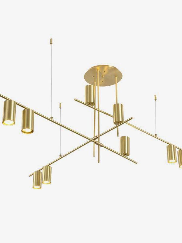 Gold-coloured crossed-rod chandelier shown against white