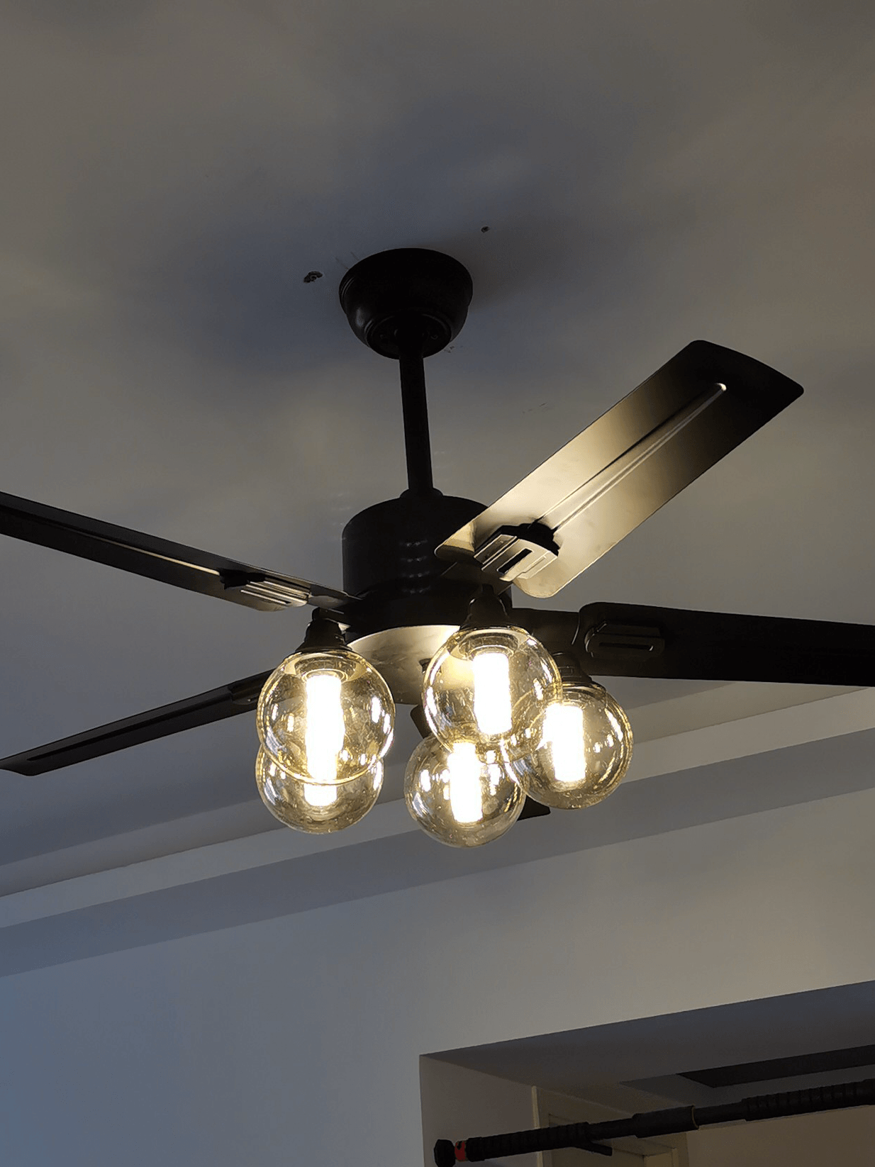 Black fan with open glass shades in an interior
