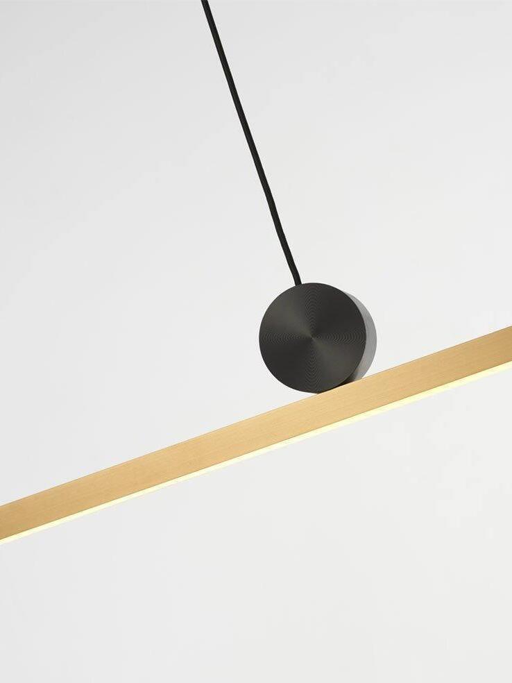 Angled view of Black disc on Gold-toned bar