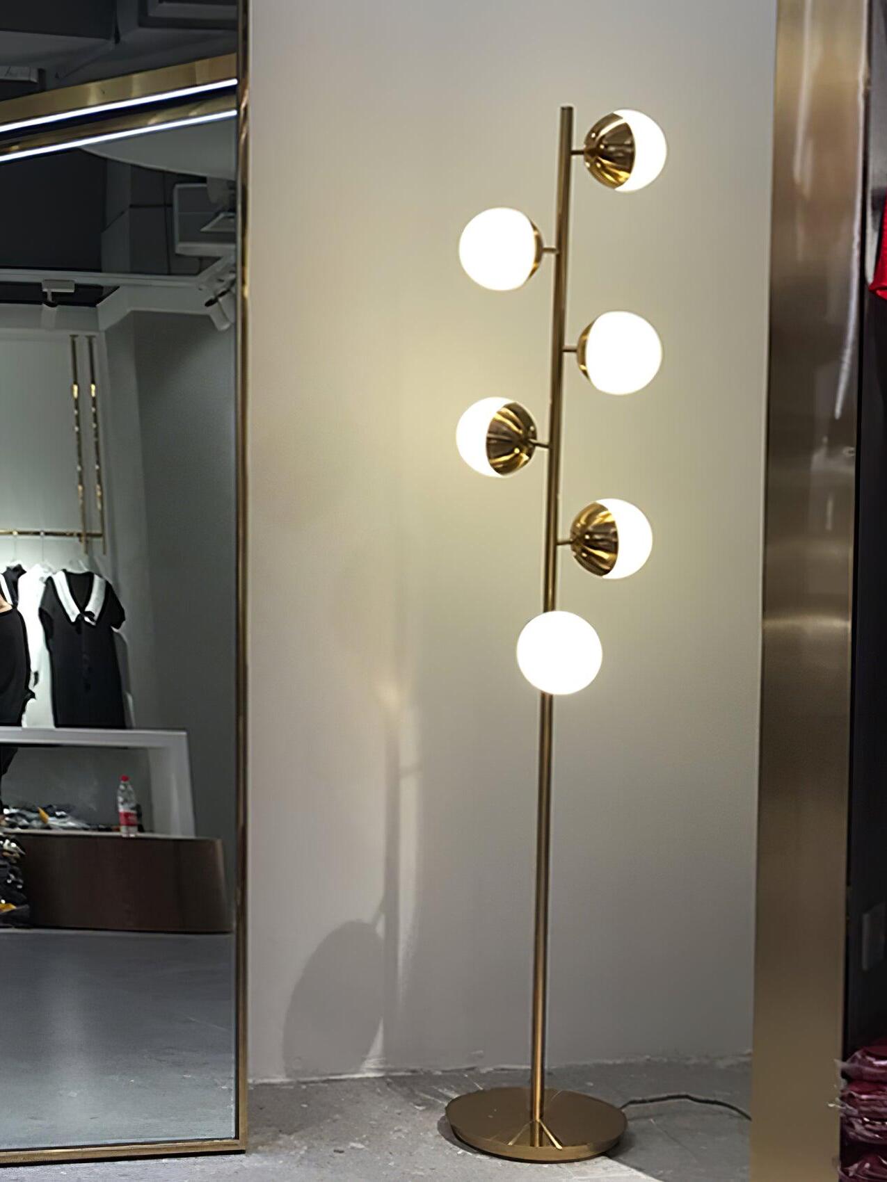Tall gold lamp beside mirror and doorway