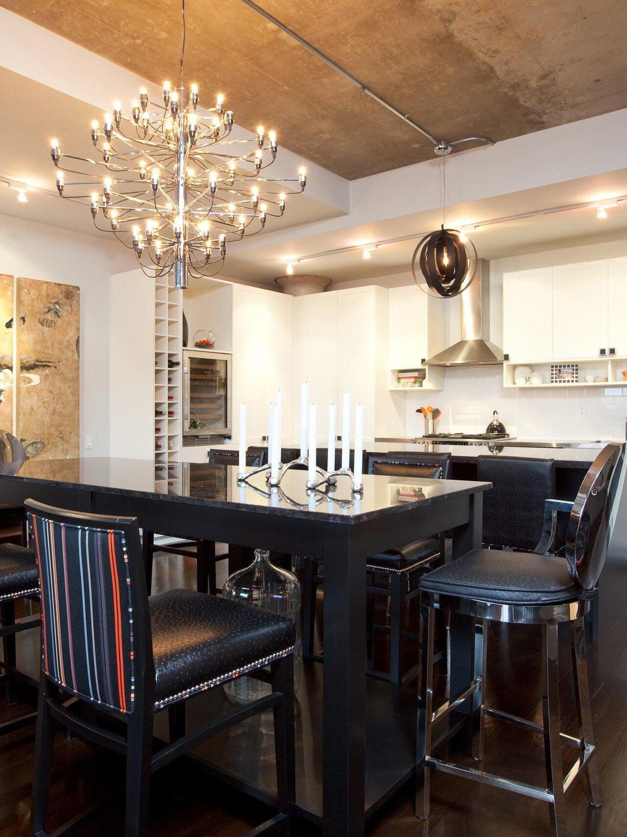 Large chandelier above a dark dining table
