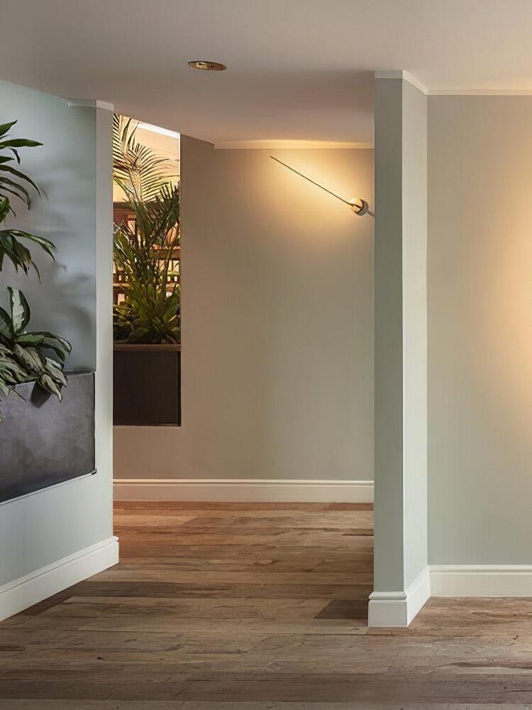 Angled Gold light rod in a hallway
