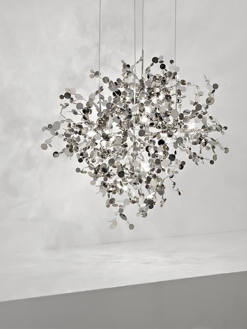Dense silver disc cluster suspended against a light wall