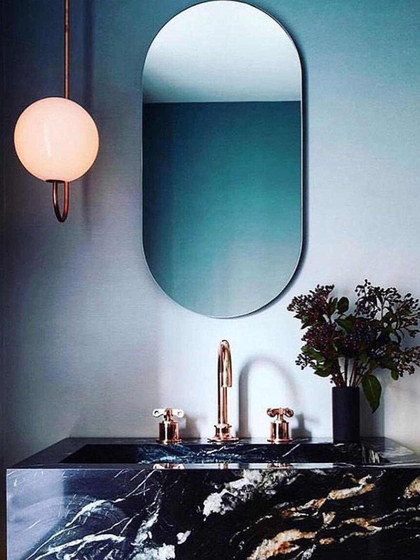 Opal globe pendant beside a blue-framed mirror