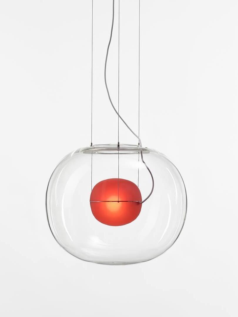 Clear pendant with red inner sphere and fine suspension lines