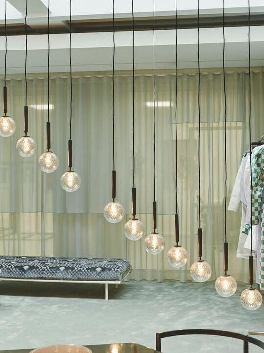 Clear globe pendants in a descending arrangement