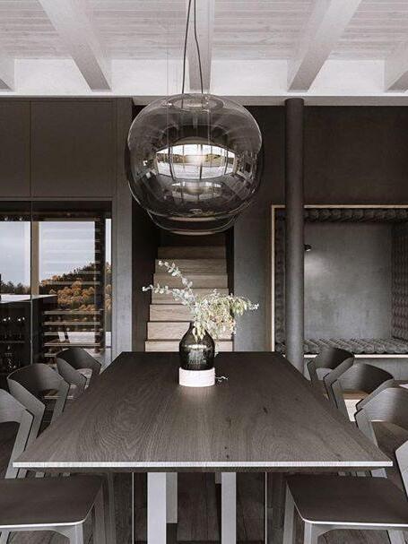 Single smoked glass globe above a wooden table