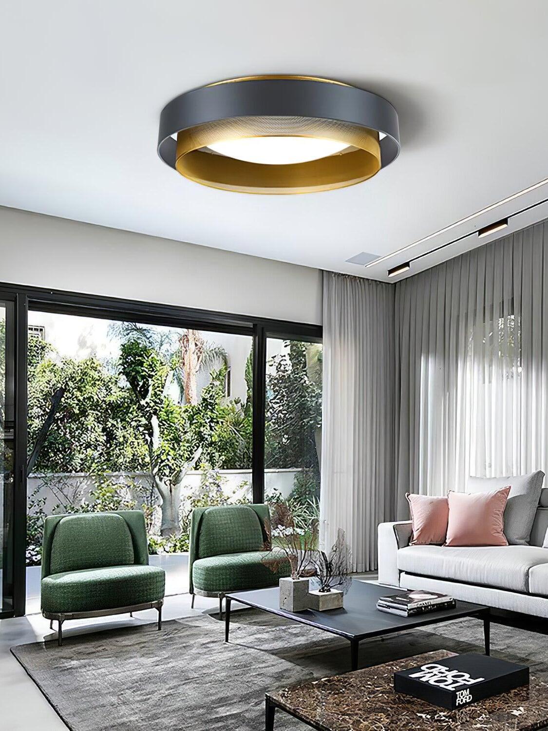 Black and gold Nolan ceiling light above green chairs, a pale sofa and a low table