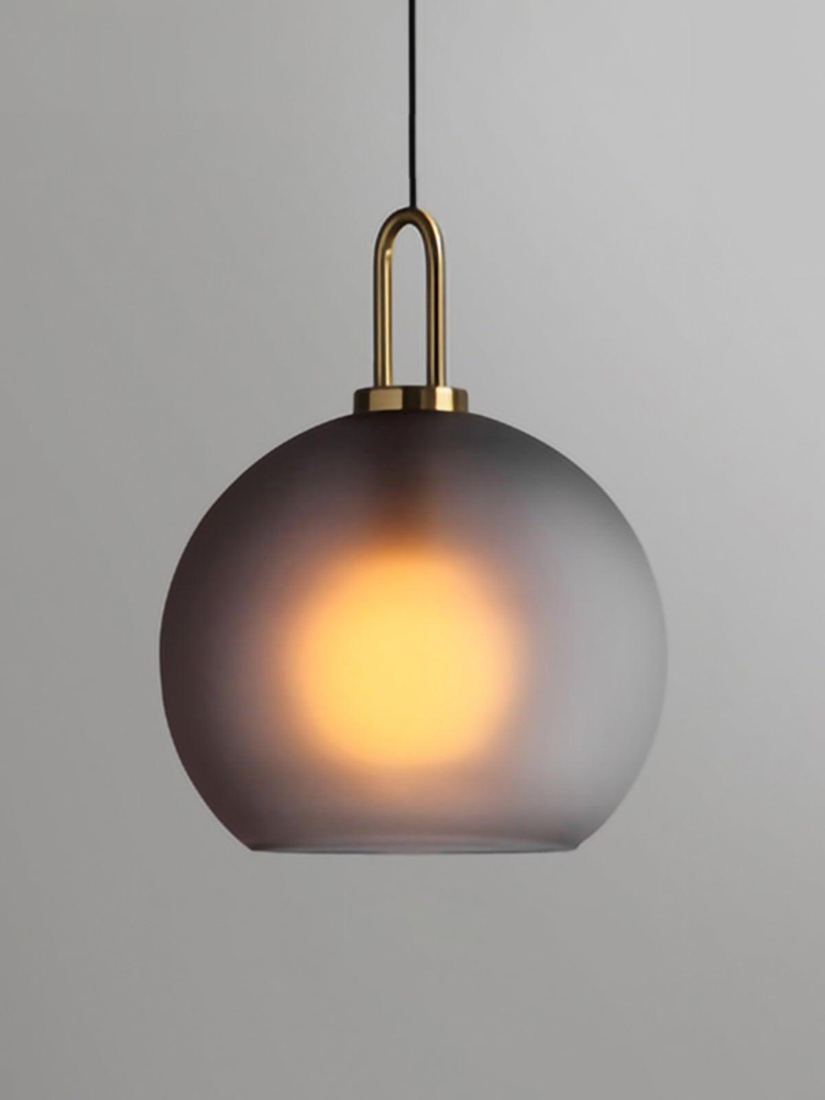 Large smoky frosted globe with a glowing bulb and metal top loop