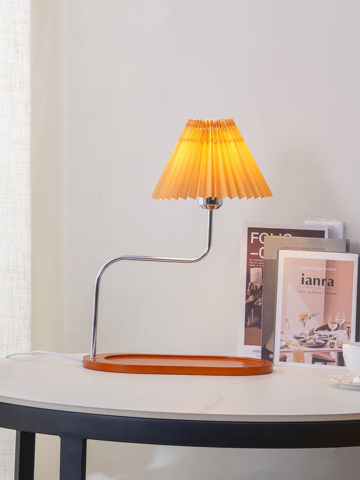 Large glowing pleated shade above oval wooden tray