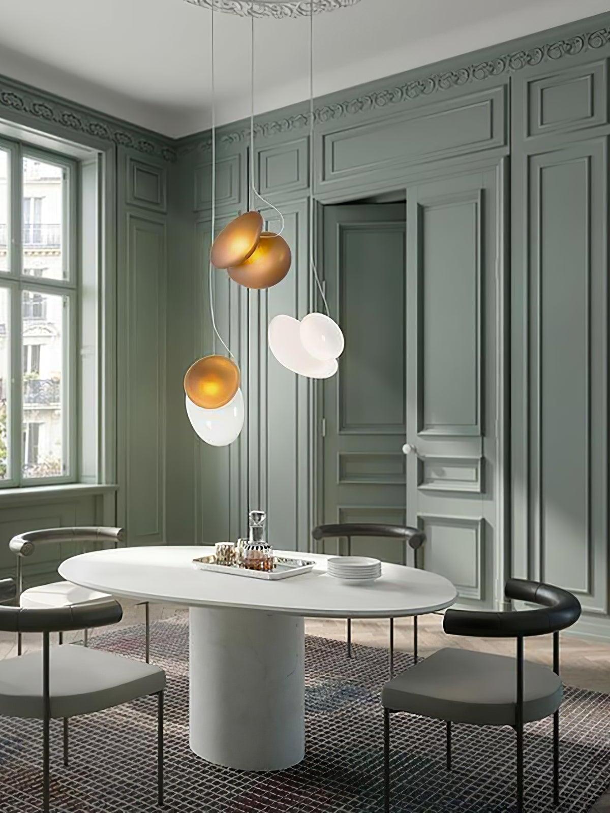 White and amber pebble pendants above a round table