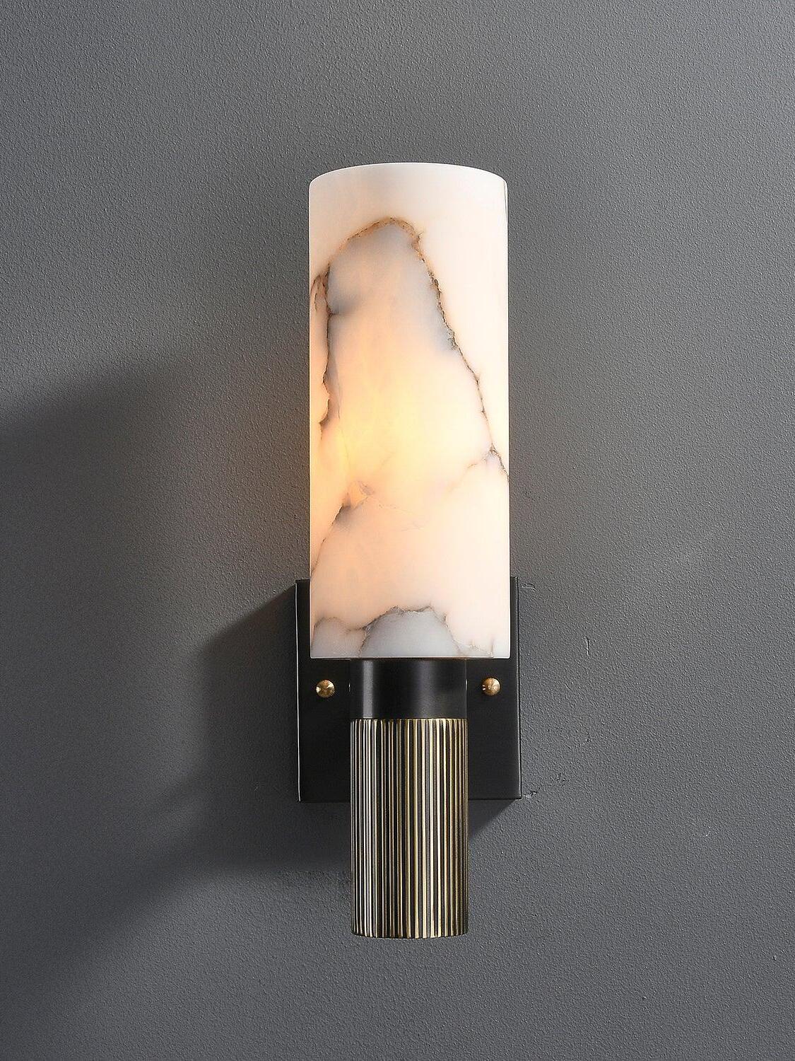 Close front view of lit white-marble sconce