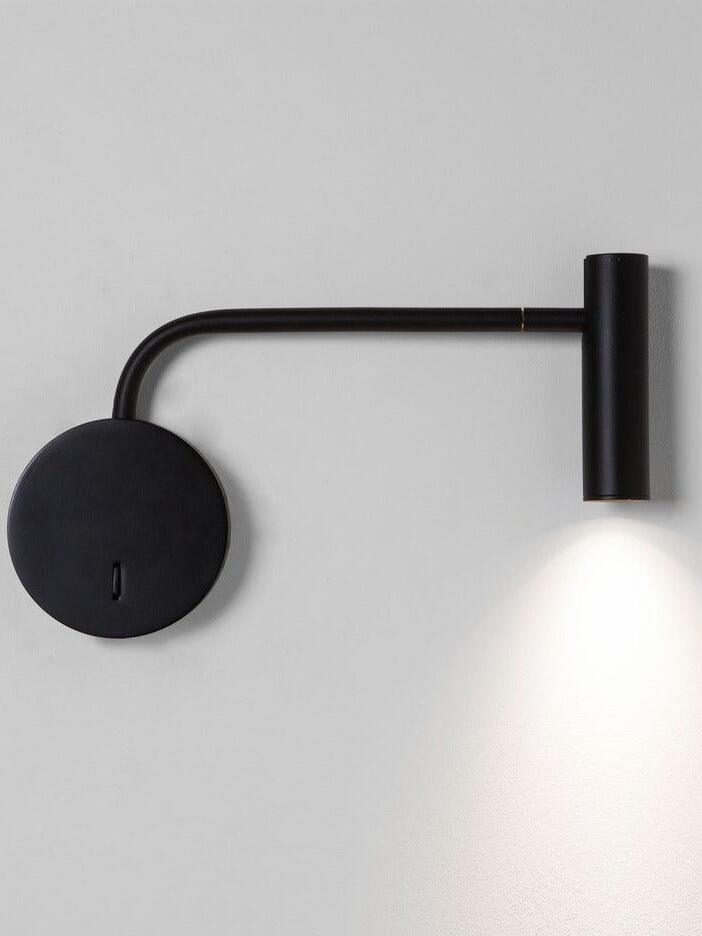 Black L-arm wall light casting light downward