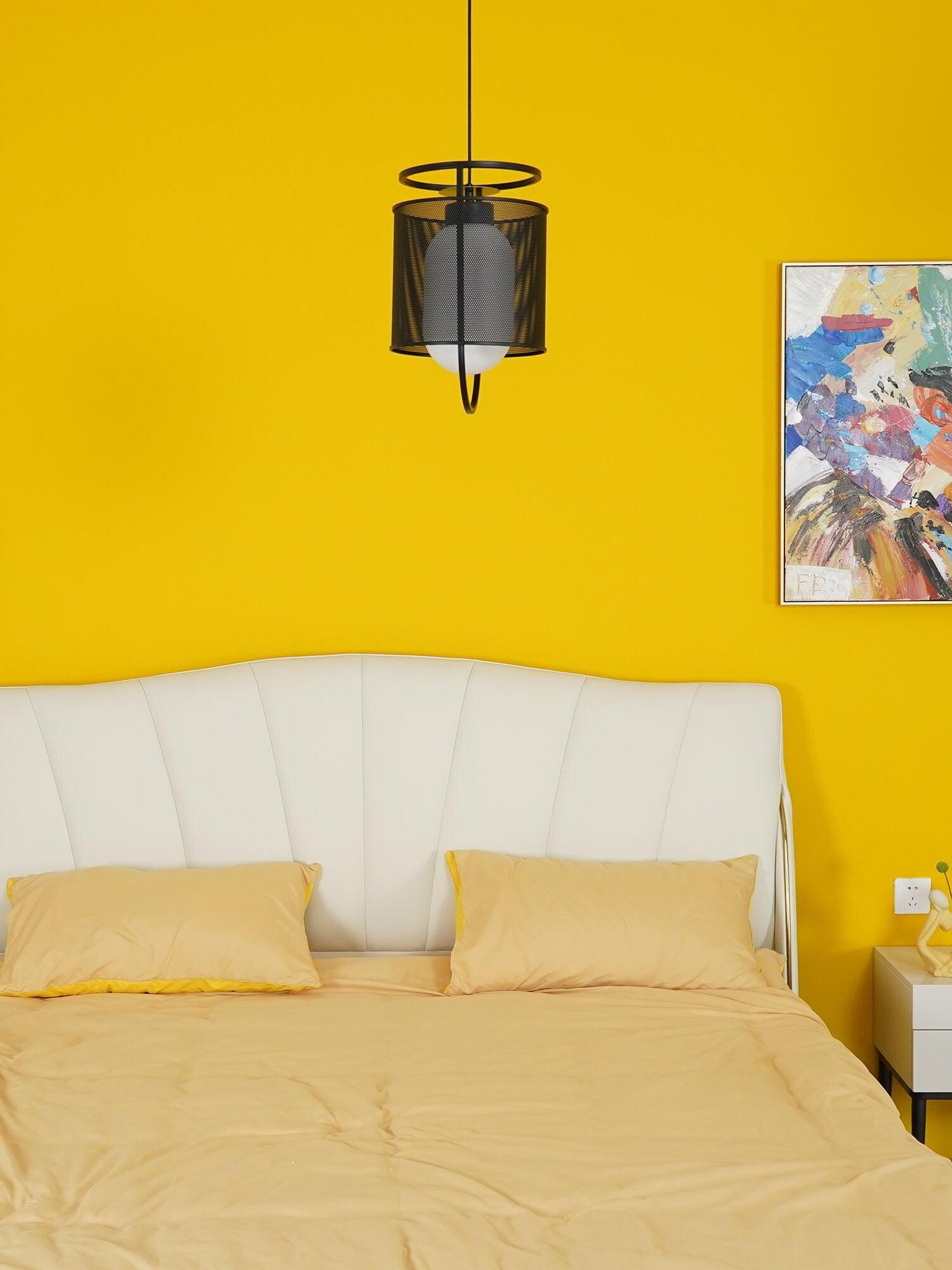 Small black mesh pendant in bedroom with yellow wall