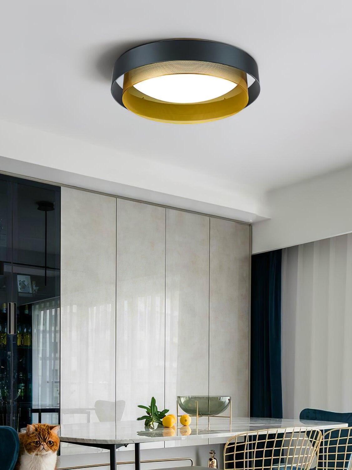 Black and gold Nolan ceiling light above dining furniture beside pale curtains