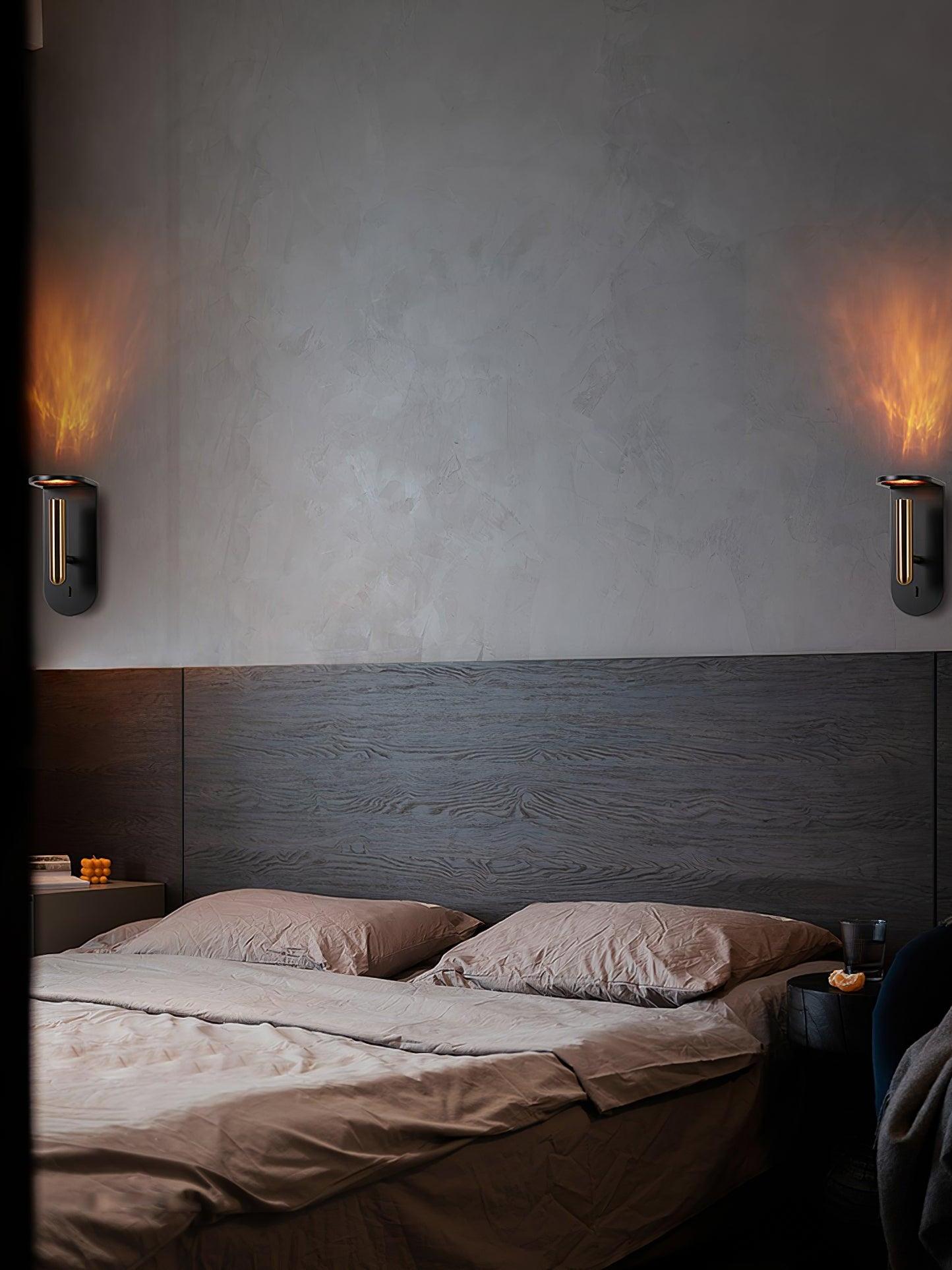 Two black Nights wall lights flanking a bed on a dark wall, with light visible above each fixture