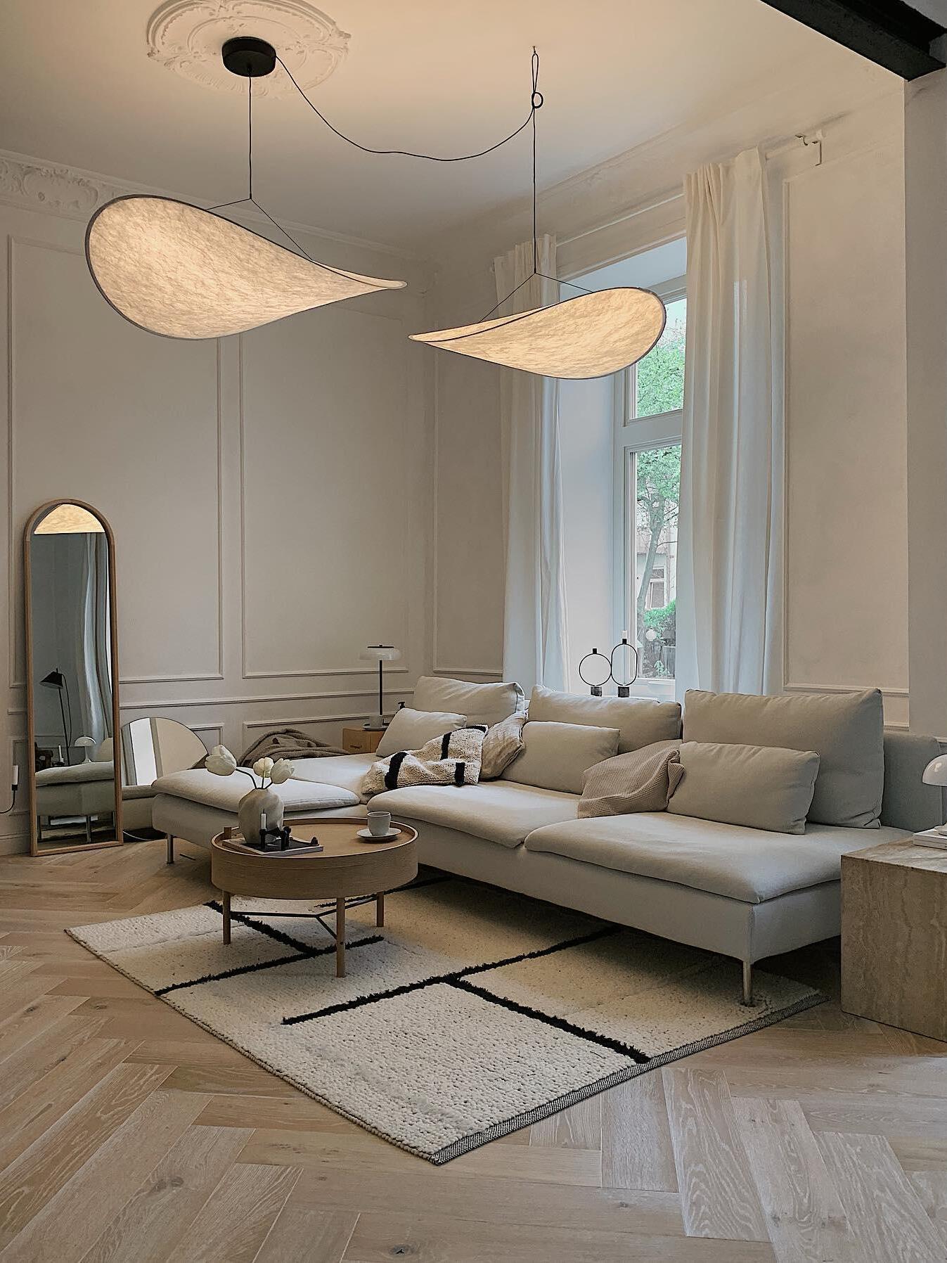 Two illuminated shades above a pale sofa