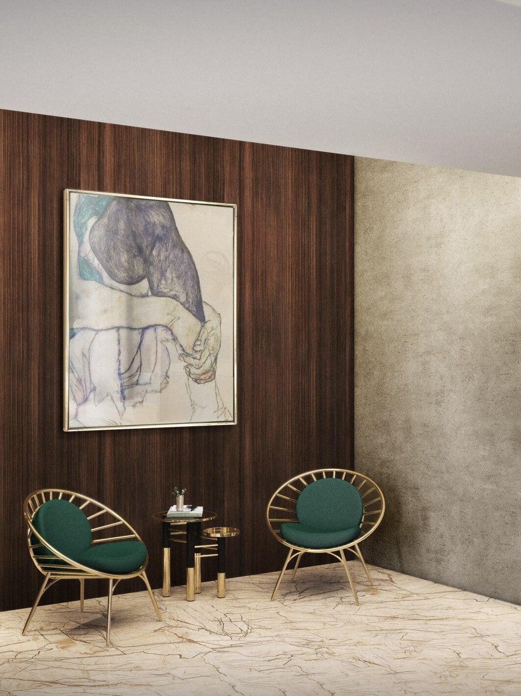 Green upholstered chairs with gold spoke frames, small round tables and framed artwork against dark wood panelling