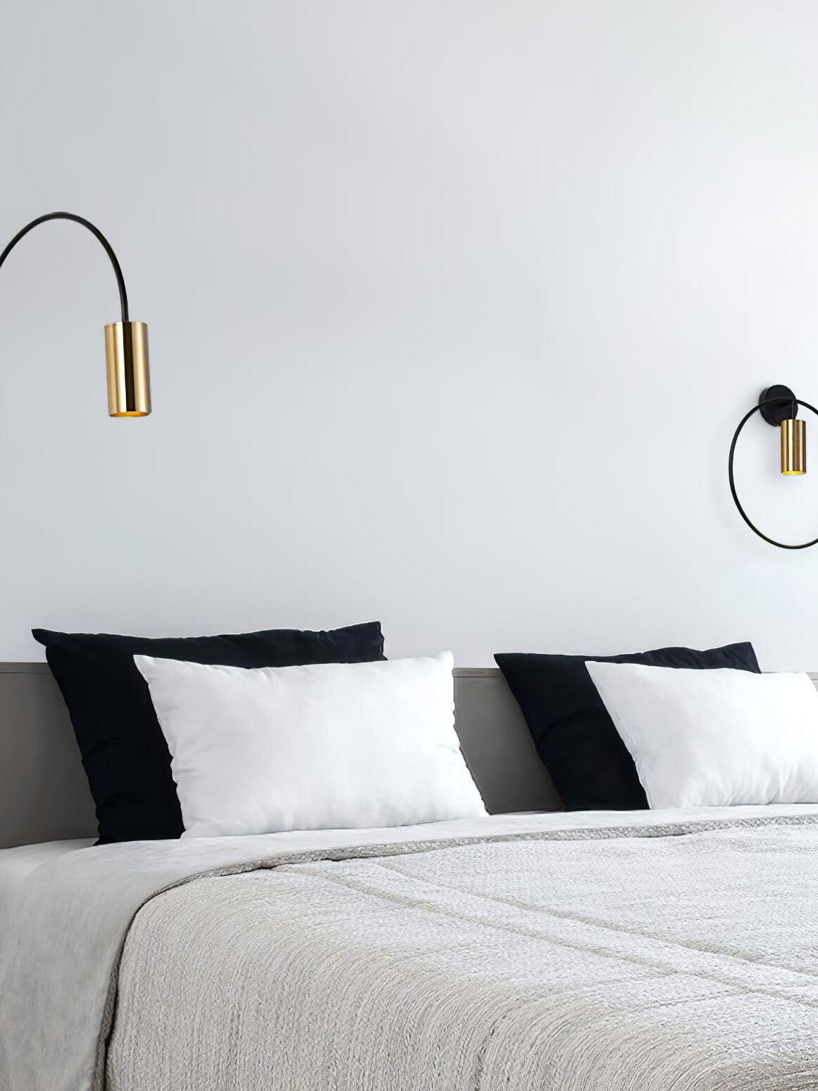 Two Antonella wall lamps positioned on either side of a bed