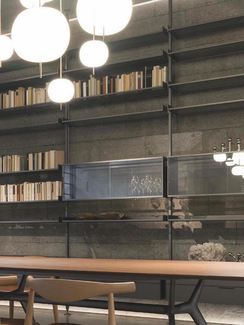 White glass pendants above a long wooden table