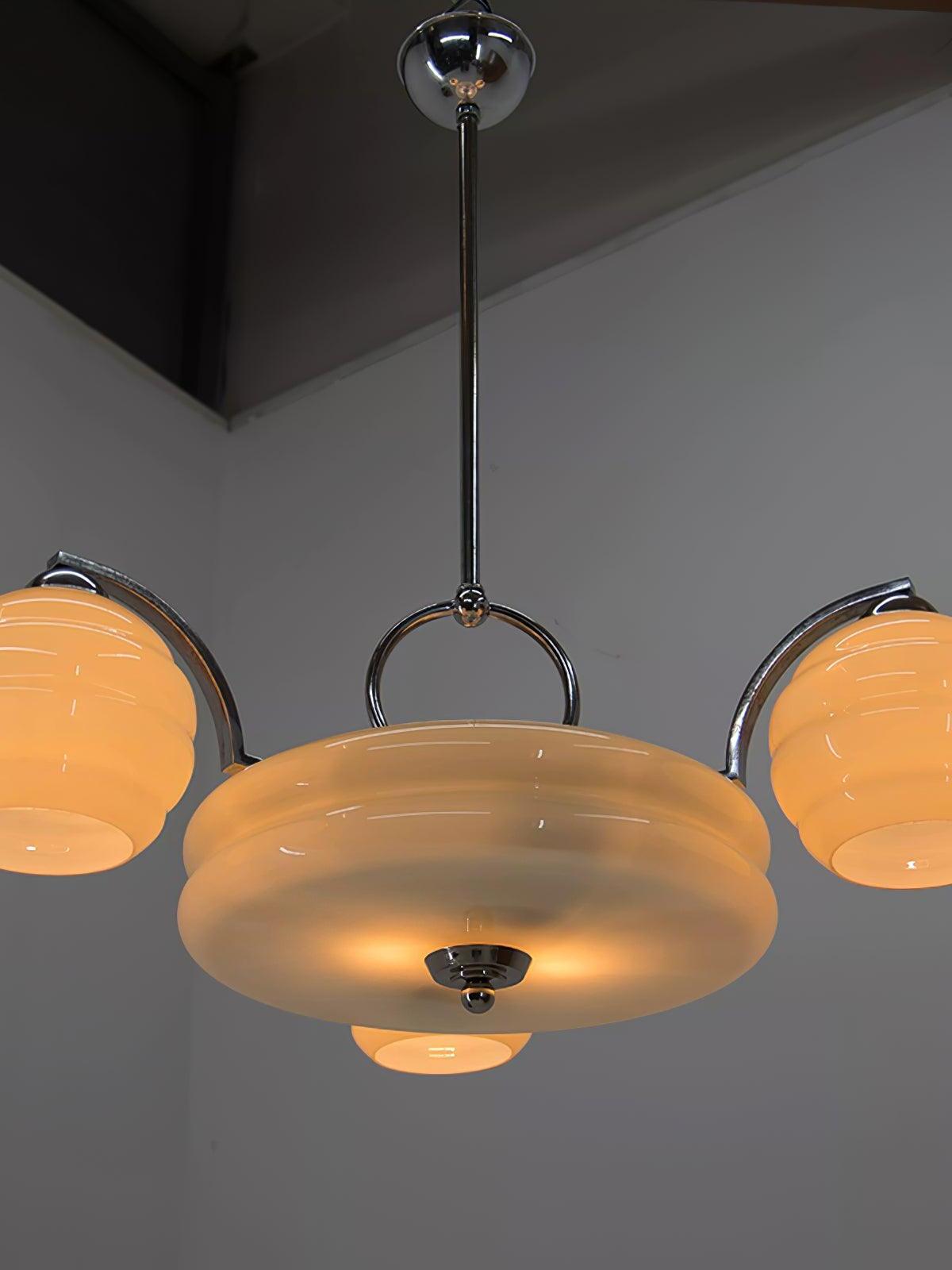 Illuminated glass chandelier on a ceiling rod