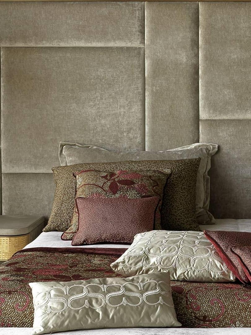 Small glass pendant near an upholstered bedhead