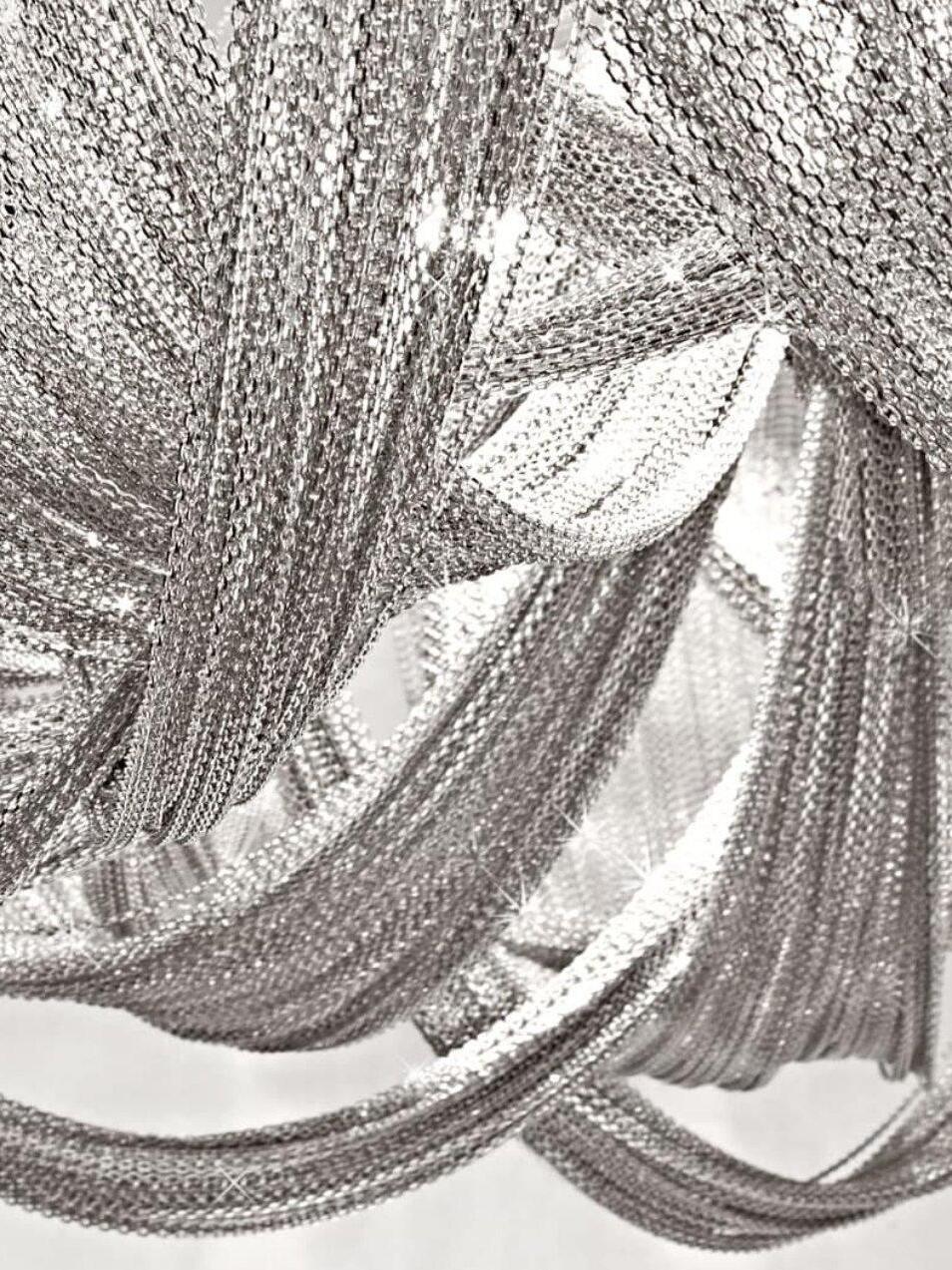 Fine silver chains draping from metal supports