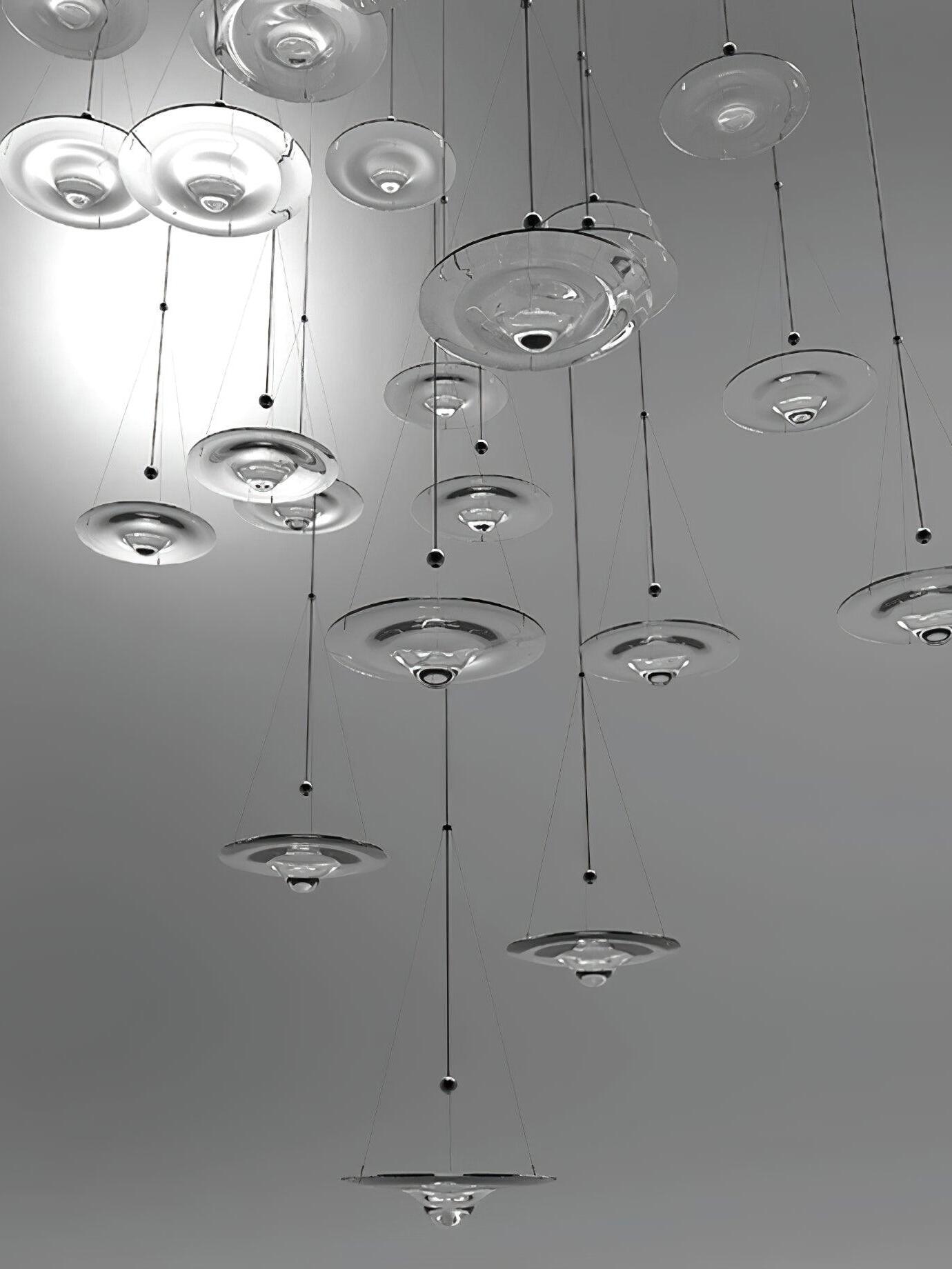 Several glass discs hanging in high-ceiling interior