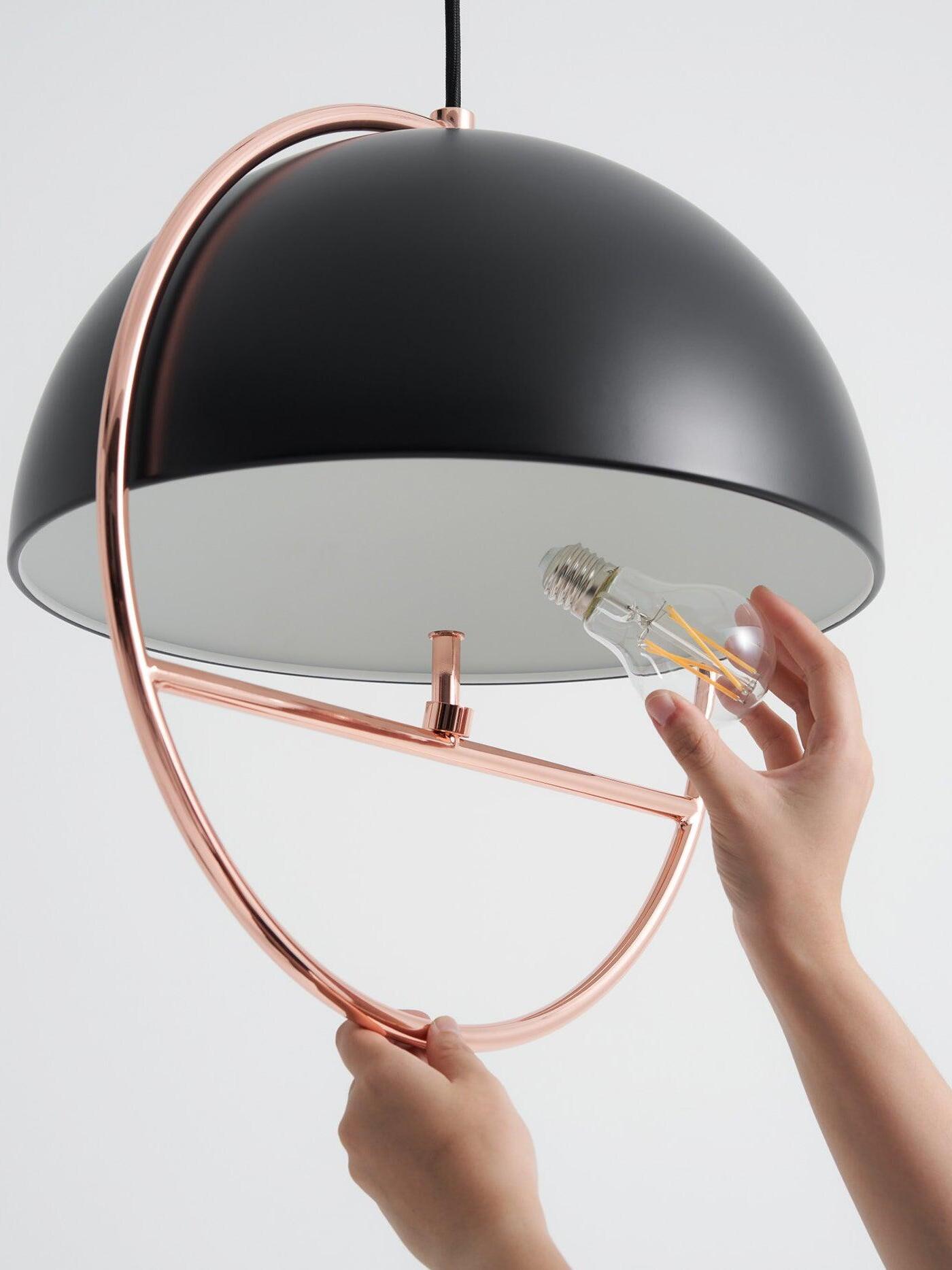 Small bulb at horizontal support of black pendant