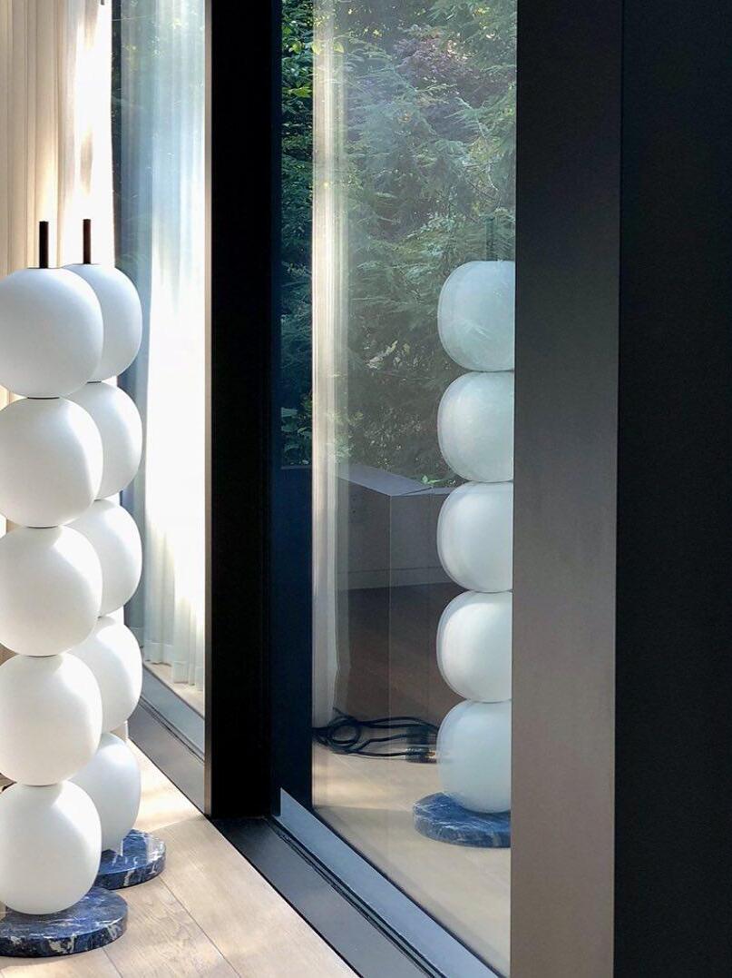 White globe lamp reflected in a window