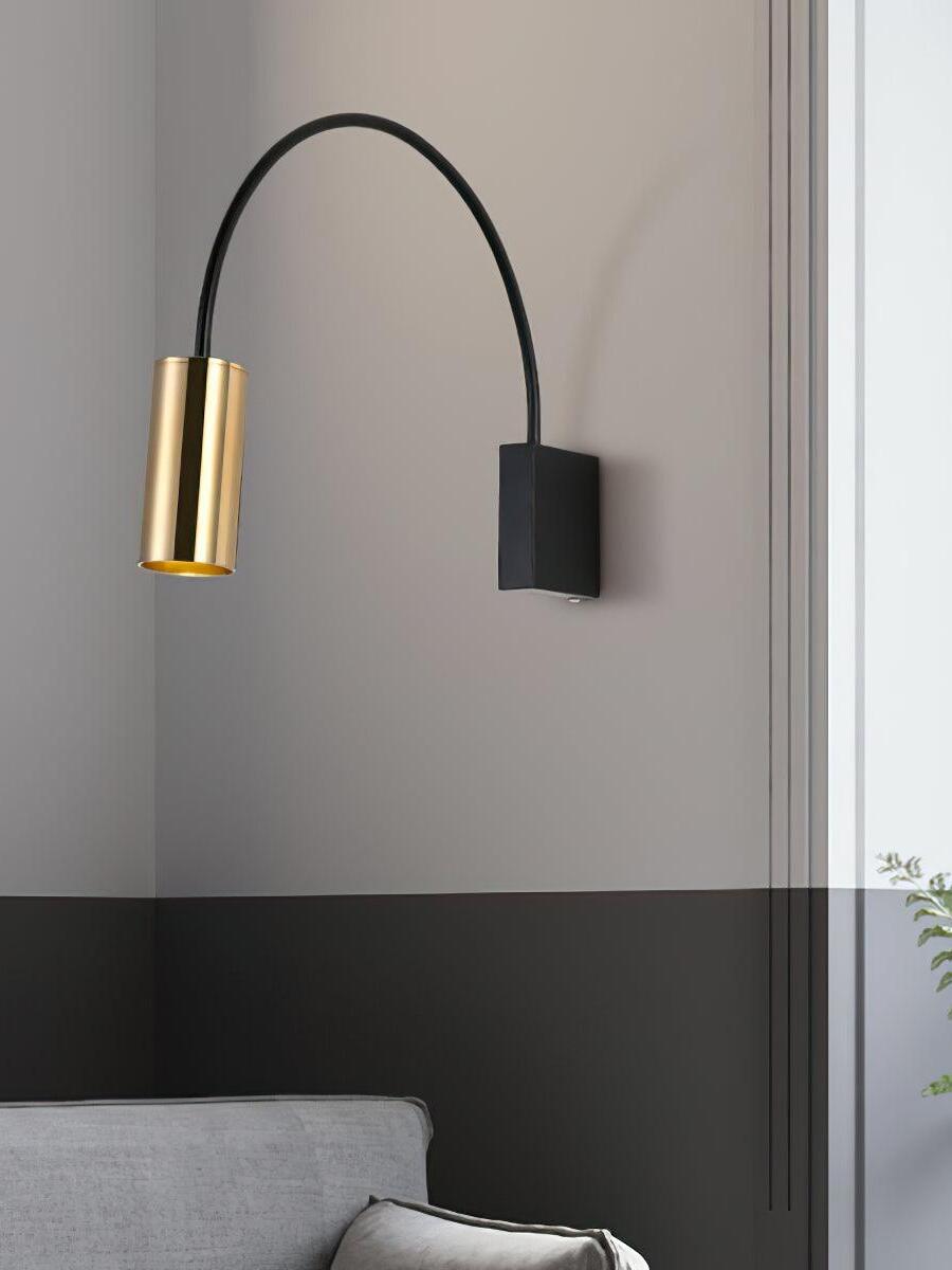 Antonella gold-headed wall spotlight against a gray wall